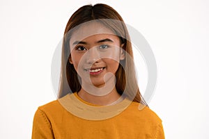 Young attractive asian girl smiling in studio