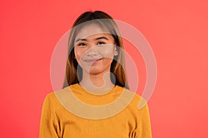 Young attractive asian girl smiling in studio