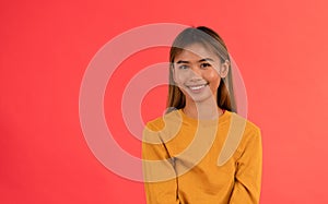 Young attractive asian girl smiling in studio