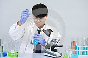 Young attractive asian scientist working in chemical laboratory