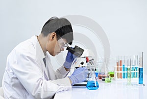 Young attractive asian scientist working in chemical laboratory