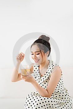 Young attractive asian woman drinking hot tea