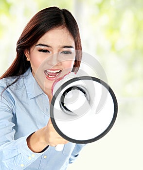 Young attractive asian woman shouting with a megaphone