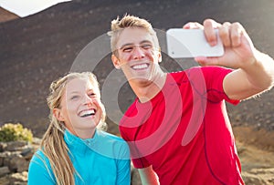 Young attractive athletic couple taking photo