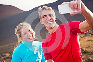 Young attractive athletic couple taking photo of themselves with