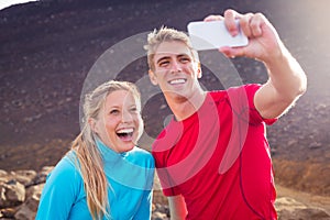 Young attractive athletic couple taking photo of themselves