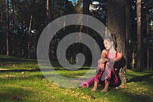 Young attractive athletic woman wearing smart watch is enjoying last rays of sun for the day after her workout