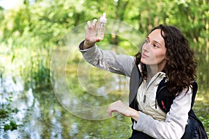 Young attractive biologist woman working on water analysis photo