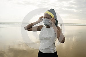 Young attractive black girl post quarantine jogging - new normal running workout of athletic and fit African American woman at