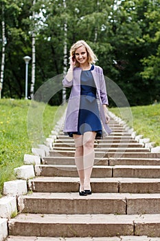 Young attractive blond woman in a summer park