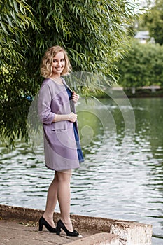 Young attractive blond woman in a summer park