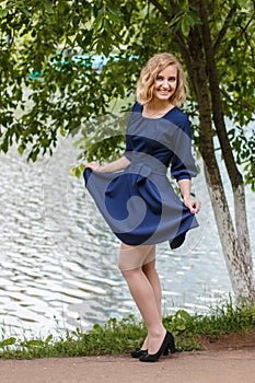 Young attractive blond woman in a summer park