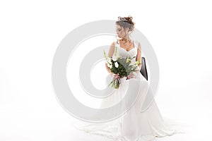 Young attractive bride with the bouquet of flowers