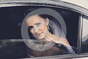 Young attractive bride gazing through the window