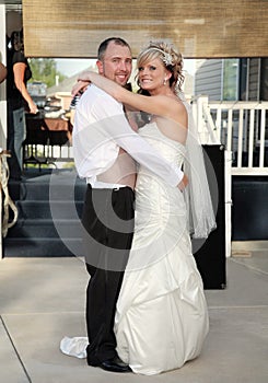 Young bride and groom dancing at wedding reception