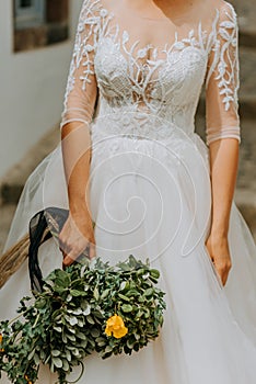 Young attractive bride holding the bouquet of flowers