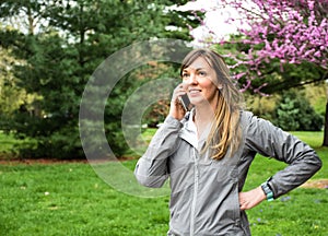 Young attractive brunette on cell phone in park
