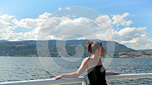 Young attractive brunette woman on the Kelowna lake front enjoying the sunshine. HD 24PS.