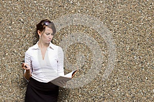 Young attractive business woman with her notebook journal