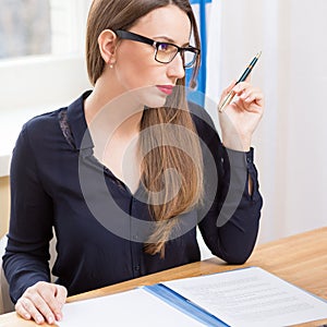 Young attractive business woman reading contract