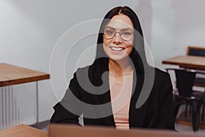 Young attractive business woman on video conference on laptop online meeting