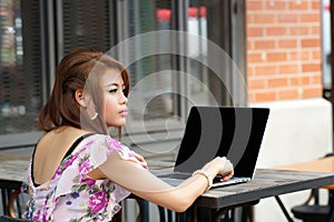 Young attractive business woman working on her laptop at outdoor