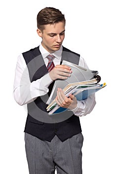 Young attractive businessman with files, folders and papers isolated on white