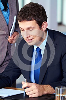 Young attractive businessman read some documents