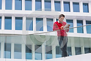 Young attractive businessman using digital tablet