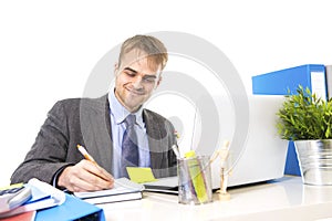 Young attractive businessman working busy with laptop computer at office desk smiling looking satisfied