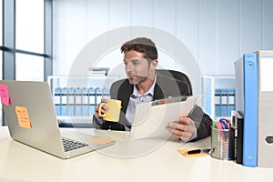 Young attractive businessman working happy confident at office with laptop computer and paperwork