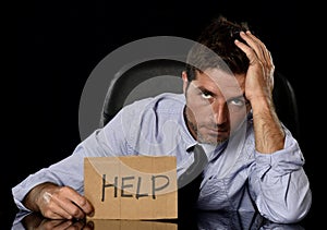 Young attractive businessman in worried tired and stressed face expression sitting depressed on office chair