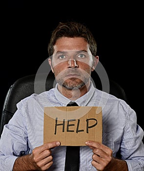 Young attractive businessman in worried tired and stressed face expression sitting depressed on office chair