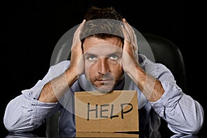 Young attractive businessman in worried tired and stressed face expression sitting depressed on office chair