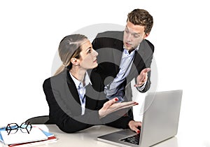 Young attractive businesswoman working at computer laptop in office arguing with work colleague in stress
