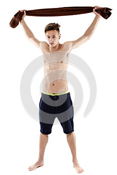 Young attractive caucasian man swimmer with goggles and towel is