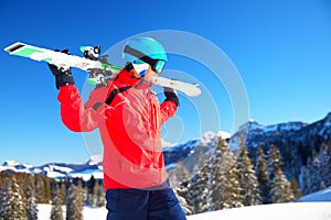 Young attractive caucasian skier with ski in Swiss Alps ready for skiing