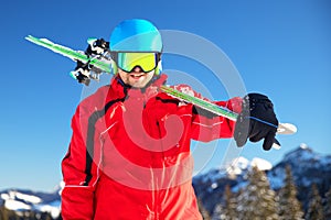 Young attractive caucasian skier with ski in Swiss Alps ready for skiing