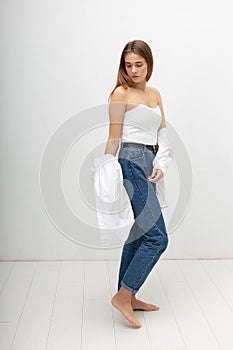 young attractive caucasian woman with long brown hair in shirt, blue jeans