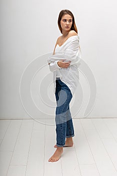 young attractive caucasian woman with long brown hair in shirt, blue jeans