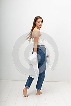 young attractive caucasian woman with long brown hair in shirt, blue jeans