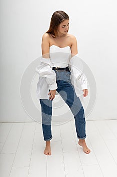 young attractive caucasian woman with long brown hair in shirt, blue jeans