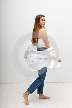 young attractive caucasian woman with long brown hair in shirt, blue jeans