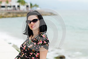 Young attractive caucausian woman enjoys sun on ocean resort du