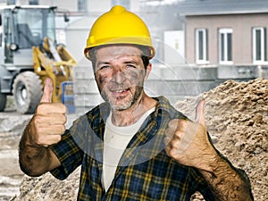 Young attractive and confident contractor or construction worker man with builder safety helmet posing corporate smiling cheerful