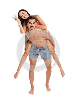 Young attractive couple in beachwear on white