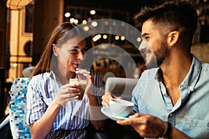 Young attractive couple on date in coffee shop