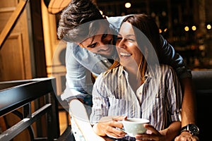 Young attractive couple on date in coffee shop