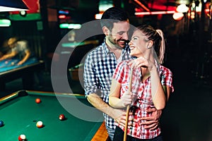 Young attractive couple on date in snooker club
