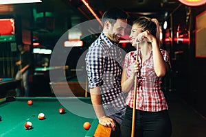 Young attractive couple on date in snooker club